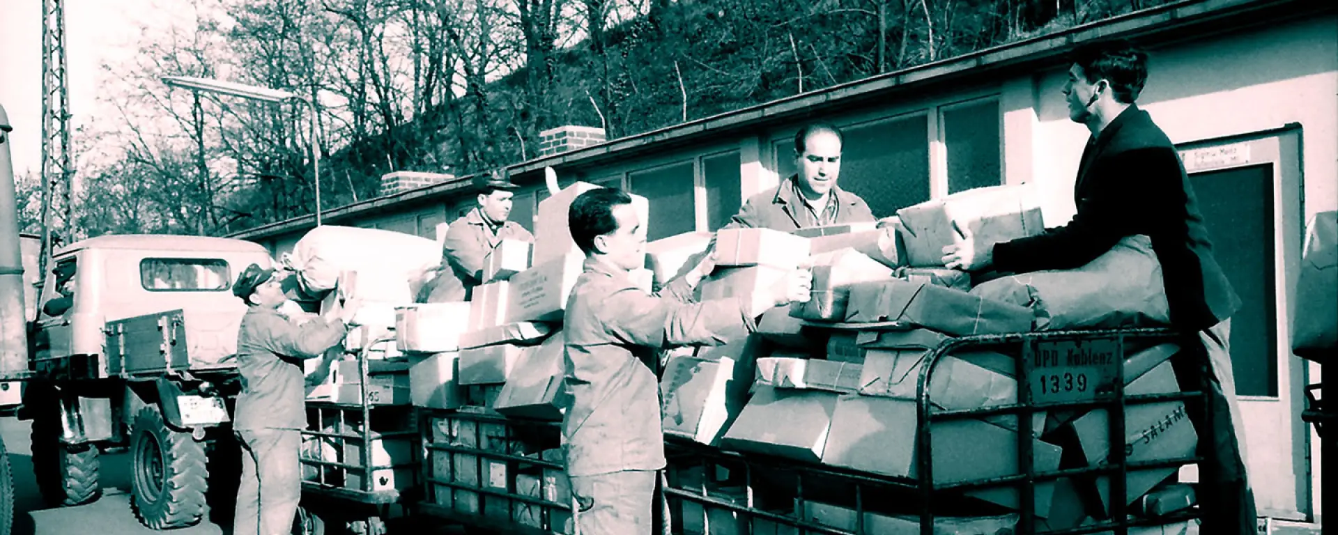 Männer beladen Bahnpost-Wagen